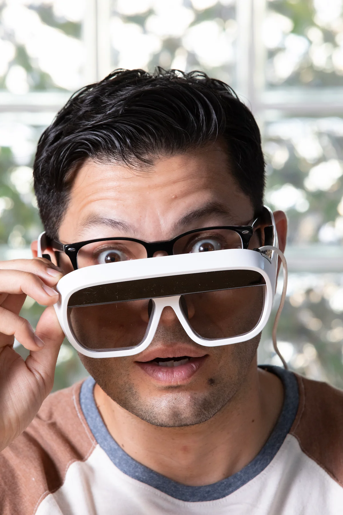 Man lowering Tilt Five glasses