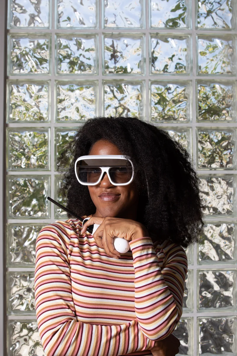 Woman looking at camera wearing Tilt Five glasses